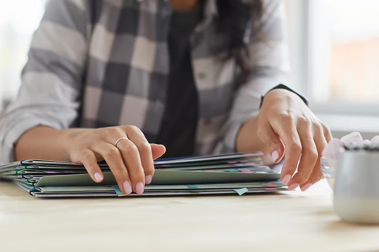 Manos organizando documentos y evidencia para construir un caso de lesiones personales